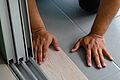 hands installing wood laminate flooring near slidi 2026 09 24 08 05 27 utc